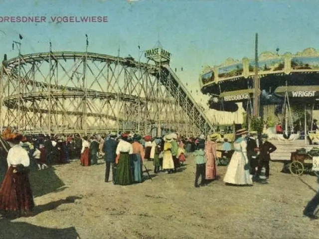 The image shows an old photo of a crowd of people at an amusement park, with a roller coaster in...