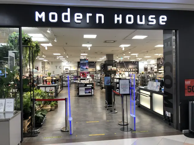 The image shows a modern house store in a mall with a sign that reads "Modern House" on the wall....